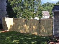 <b>6 foot high Pressure Treated Vertical Board Fence with Facia Board on Top and Bottom and Dog Earred Posts-Arched Walk Gate</b>